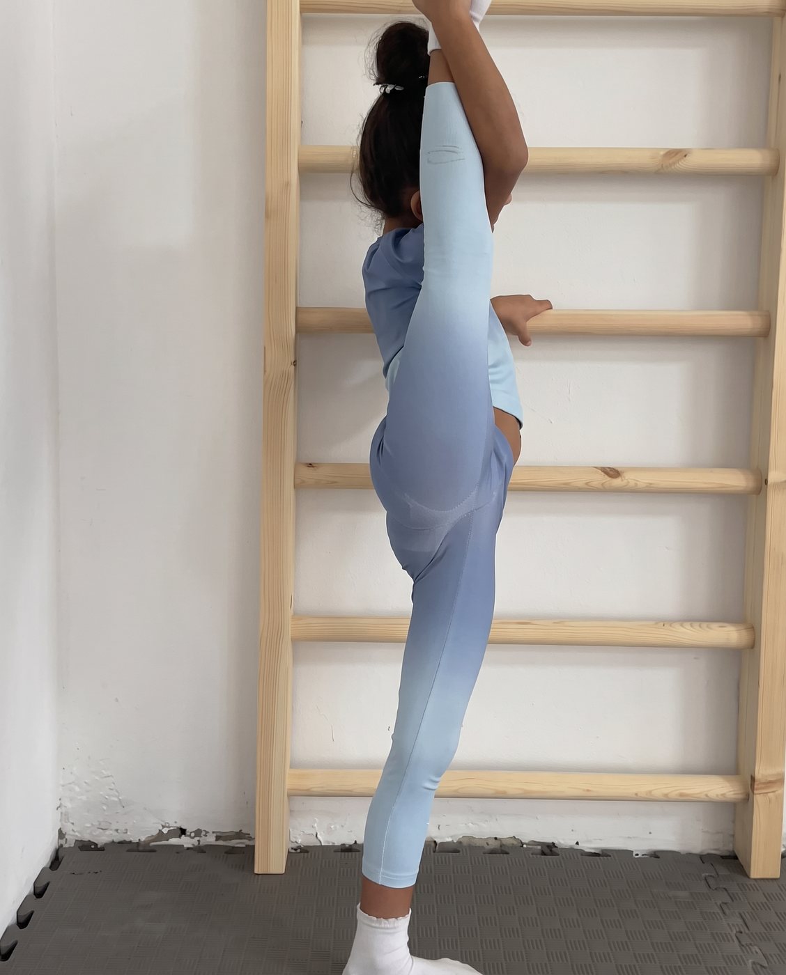 Standing split at the wall bars